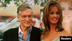 FILE - Karen McDougal, who had recently been named Playboy magazine's Playmate of the Year, poses with Playboy founder Hugh Hefner, May 28, 1998, during ceremonies at the Playboy Mansion in Beverly Hills, California.