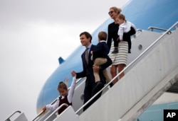FILE - Arabella Kushner, her father, White House senior adviser Jared Kushner, carrying Joseph Kushner, and Ivanka Trump, carrying Theodore Kushner, step off Air Force One at the Palm Beach International Airport, in West Palm Beach, Florida, March 3, 2017. Ivanka Trump is wearing a skirt from her own collection. Despite efforts to address ethical concerns, Trump remains, for many, the living embodiment of the brand that bears her name.