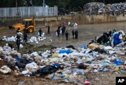 Activists from the You Stink anti-government movement remove trash from the Beirut River as it flows towards the Mediterranean Sea, in Karantina, east Beirut, Lebanon, Oct. 25, 2015.
