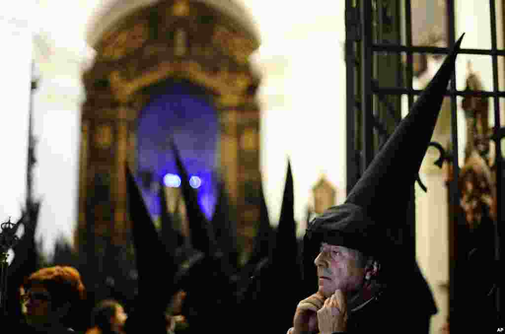 Penitents from "Los Dolores" brotherhood gather prior to a Holy Week procession in Cordoba, southern Spain. Hundreds of processions take place throughout Spain during the Easter Holy Week.