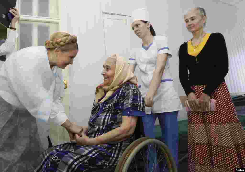 Former Ukrainian prime minister and current presidential candidate Yulia Tymoshenko (L) visits a hospital during her election campaign in the city of Sumy May 21, 2014. Campaigning for Ukraine's presidential election, Tymoshenko says she alone can save th