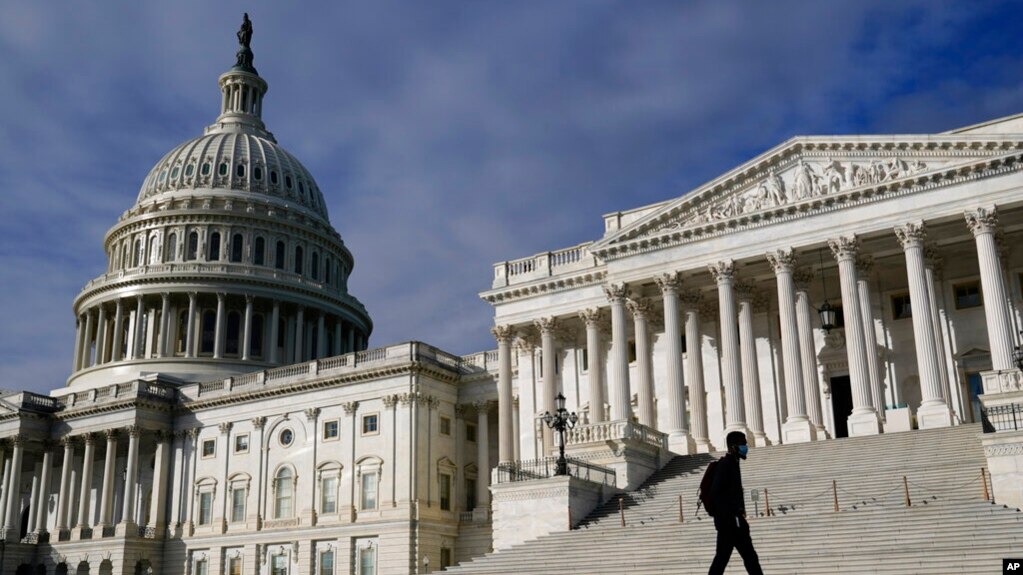 A man walks past the the U.S. Capitol, in Washington, Oct. 27, 2021.