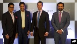 The eldest son of U.S. President Donald Trump, Donald Trump Jr., second from right, poses with promoters of Trump Towers in New Delhi, India, Feb. 20, 2017.