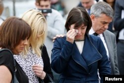 Labour MP's (L-R) Paula Sheriff, Lucy Powell, and Jeff Smith, and former Labour Party councillor Karen Rowling (2nd L), leave tributes near the scene of the murder of Labour Member of Parliament Jo Cox in Birstal near Leeds, Britain, June 17, 2016.