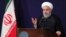 In this photo released by the official website of the office of the Iranian Presidency, President Hassan Rouhani addresses the nation in a televised speech in Tehran, Aug. 6, 2018.