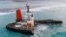 Une vue aérienne prise à Maurice le 17 août 2020 montre le vraquier MV Wakashio, appartenant à une société japonaise mais battant pavillon panaméen, qui s'était échoué et s'était brisé en deux près du parc marin de Blue Bay.