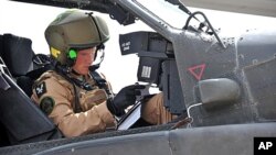 This is an undated handout photo issued by Britain's Ministry of Defense of Prince Harry as he prepares his Apache helicopter to go out on a mission in El Centro, California, February 8, 2012.