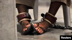 FILE - A detainee's feet are seen shackled to the floor inside the Camp 6 high-security detention facility at Guantanamo Bay U.S. Naval Base, April 27, 2010.