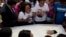 FILE - Michele de Oliveira grieves over the coffin containing her 13-year-old son, Paulo Henrique Oliveira, in Rio de Janeiro, Brazil, April 26, 2017. Paulo lived with his family in the Alemao complex of slums and was walking to visit a neighbor when he w