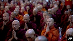 FILE - Controversial Buddhist monk Wirathu, second right foreground, who is accused of instigating sectarian violence between Buddhists and Muslims through his sermons.