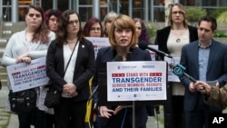 FILE - Gender Justice League executive director Danni Askini speaks during a press conference following oral arguments in a case to block a transgender military ban at the U.S. Western District Federal Courthouse, March 27, 2018, in Seattle.