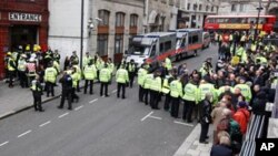 Emergency service personnel escort people with mock injuryies away during an exercise of a simulated terrorist attack on the London Underground network at a disused tube station in central London, Wednesday, Feb. 22, 2012. British police, fire and ambulan