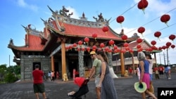 Tourists visit a temple on the first day of the Lunar New Year of the Snake in Denpasar, Indonesia's Bali island, on Jan. 29, 2025.