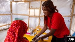 FILE—25-year-old nutritionist Isabelle Mamabey checks a Sudanese child who suffers from severe acute malnutrition in the Koufroun refugee camp, on April 9, 2024.