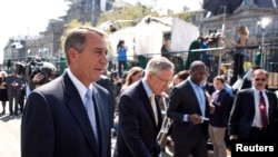 File - Speaker of the House John Boehner (L) and Senate Majority Leader Harry Reid