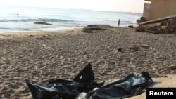 FILE - Bags containing the bodies of migrants who died after their boat capsized off coast of Komas, are seen in the town east of the capital Tripoli, Libya, July 26, 2019. At least 45 migrants died earlier this week in a shipwreck, according to reports. 