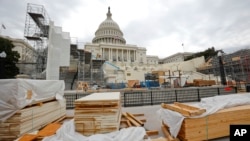 Building materials are stacked as construction continues on the inaugural platform in preparation for the swearing-in ceremonies for President-elect Donald Trump on the Capitol steps in Washington, Dec. 8, 2016. Trump will be sworn in as president on Jan.