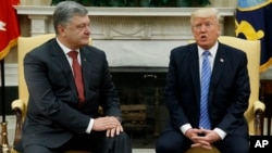 President Donald Trump, right, speaks during a meeting with Ukrainian President Petro Poroshenko in the Oval Office of the White House, in Washington, June 20, 2017.