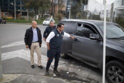 Wilson Florez, candidate of Democratic Center political party for the government of Cundinamarca, disembarks from his armored SUV, accompanied by his bodyguard, in Bogota, Colombia, Oct. 23, 2019.