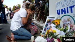 FILE - A woman reacts at a make shift memorial outside the Al-Noor mosque in Christchurch, New Zealand, March 23, 2019.