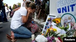 A woman reacts at a make shift memorial outside the Al-Noor mosque in Christchurch, New Zealand, March 23, 2019.