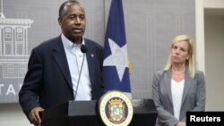 Housing and Urban Development Secretary Ben Carson, left, addresses the media along with Homeland Security Secretary Kirstjen Nielsen, while visiting San Juan, Puerto Rico, Dec. 19, 2017.