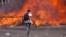 Zimbabwe's opposition supporters set up a burning barricade as they clash with police during a protest for electoral reforms, Aug. 26, 2016 in Harare, Zimbabwe.
