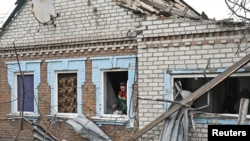 A municipal worker inspects a house damaged by a Russian drone strike, amid Russia's attack on Ukraine, in Zaporizhzhia, Ukraine, November 25, 2024. 