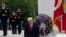 President Donald Trump stands with Vice President Mike Pence and General Omar Jones, Commanding General at Joint Force Headquarters, as they attend a Memorial Day tribute at Arlingon National Cemetery, outside Washington, May 25, 2020. 