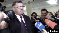 Social-democratic party leader Algirdas Butkevicius speaks to the media as he casts his vote in Vilnius, October 14, 2012. 