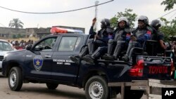 FILE - Congolese police patrol outside the main prison in Kinshasa, Democratic Republic of the Congo, May 17, 2017. 