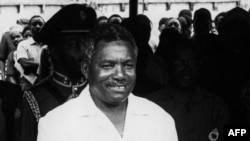 FILE - Tanzania's President-elect Ali Hassan Mwinyi poses with the outgoing president and the man who takes over as Zanzibar's president in Dar es Salaam, on October 1985. 