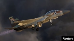 FILE - An Israeli Air Force F-15 fighter jet flies during an aerial demonstration at a graduation ceremony for Israeli airforce pilots at the Hatzerim air base in southern Israel.