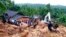 Sri Lankans watch military rescue efforts at the site of a landslide at Bellana village in Kalutara district, Sri Lanka, May 26, 2017. Mudslides and floods triggered by heavy rains in Sri Lanka killed dozens and left many more missing. 