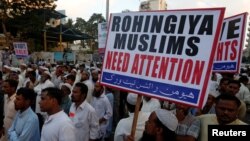 A Human Rights Network activist holds a sign during a demonstration against the persecution of Rohingiya Muslims in Myanmar, in Karachi, Pakistan, Dec. 9, 2016.