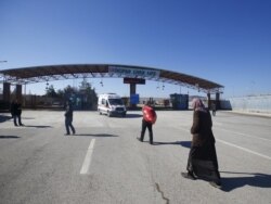 FILE - Syrians walk at Turkey's Oncupinar border crossing on the Turkish-Syrian border in the southeastern city of Kilis, Turkey, February 9, 2016.