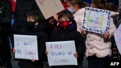 Los niños participan en una protesta exigiendo que las escuelas públicas permanezcan abiertas, afuera del Ayuntamiento de Nueva York el 19 de noviembre de 2020.