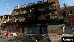 A boy looks at the site of a car bomb attack in a neighborhood of northern Baghdad August 11, 2013.