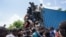 Residents overtake a truck loaded with relief supplies in Vye Terre, Haiti, Aug. 20, 2021.
