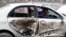 A man sits in his car which is damaged after a bomb attack in Quetta, April 24, 2013.