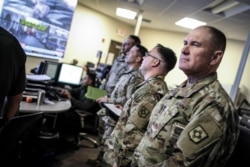 FILE - Image provided by U.S. Customs and Border Protection shows members of the New Mexico Army National Guard visiting the U.S. Border Patrol office in El Paso, Texas, April 7, 2018.