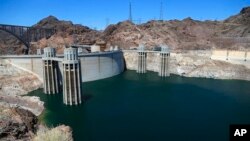 FILE - The low level of the water line is shown on the banks of the Colorado River at the Hoover Dam in Hoover Dam, Arizona, May 31, 2018.