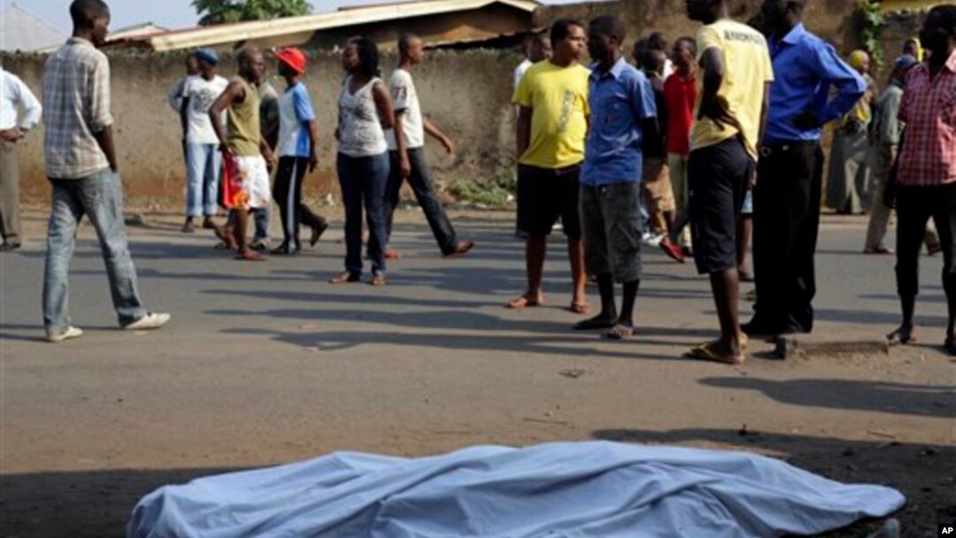 The body of a man killed is laid on a street in Bujumbura, Burundi after polls opened for the presidential elections Tuesday, July 21, 2015. Violence began in April after President Pierre Nkurnziza announced he would seek a third term in office, which the political opposition called unconstitutional. (AP Photo/Jerome Delay)