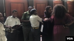 Marry Chiwenga with her relatives and prison guards at a Harare court.