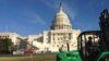 A tractor drives on the U.S. Capitol lawn near the site where President Barack Obama's swearing-in ceremony will be held in January 2013. (Photo: VOA/Sandra Lemaire)