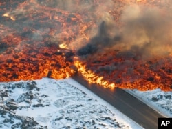 Lava crosses the main road to Grindavík, Iceland, on Feb. 8, 2024.