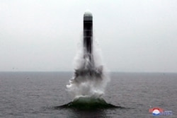 FILE - What appears to be a submarine-launched ballistic missile (SLBM) flies at an undisclosed location in this undated photo released by North Korea's Central News Agency (KCNA), Oct. 2, 2019.