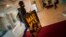 FILE - A spectator arrives at the Maria Victoria cinema to watch ''Mad Max. Fury Road'' during the 63rd San Sebastian Film Festival, in San Sebastian, northern Spain, Sept. 18, 2015.
