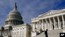 FILE - A man walks past the the U.S. Capitol, Oct. 27, 2021.