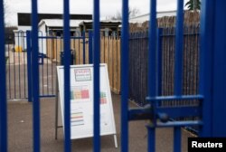 General view of a sign outside the Parkside Community Primary School in Borehamwood as the spread of the coronavirus disease (COVID-19) continues, in Borehamwood, Britain, March 18, 2020.